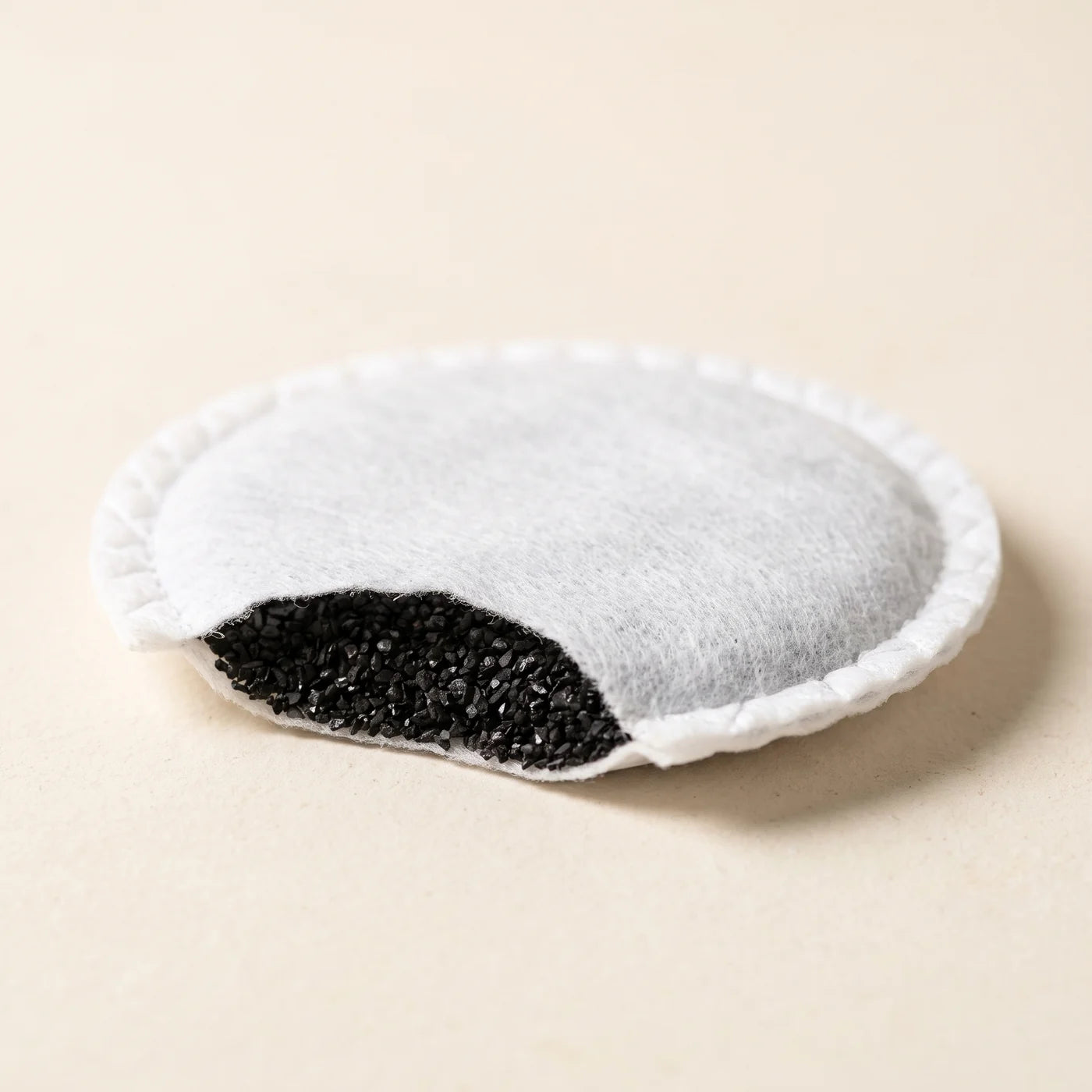 A BRIM carbon filter pad, cut away to show the activated carbon granules inside